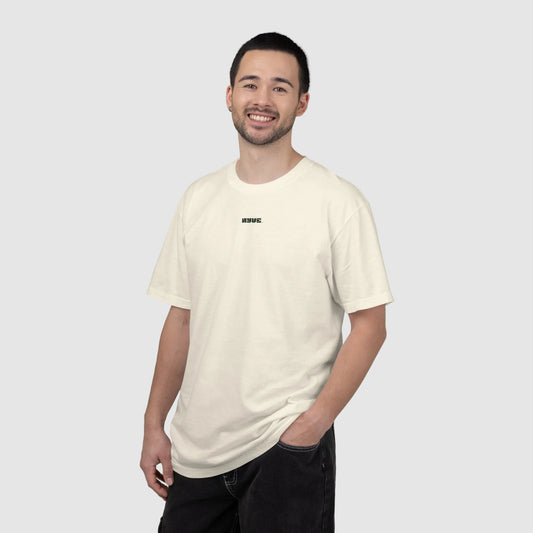 Man wearing a beige t-shirt with a small logo on a white background