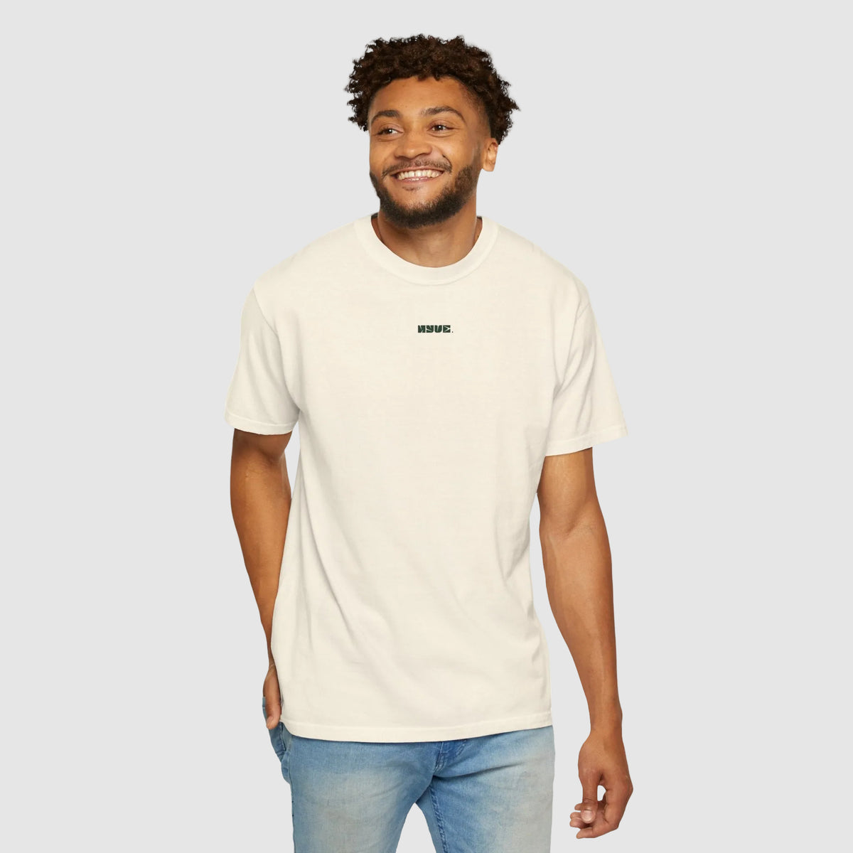 Man wearing a beige t-shirt with text on a white background